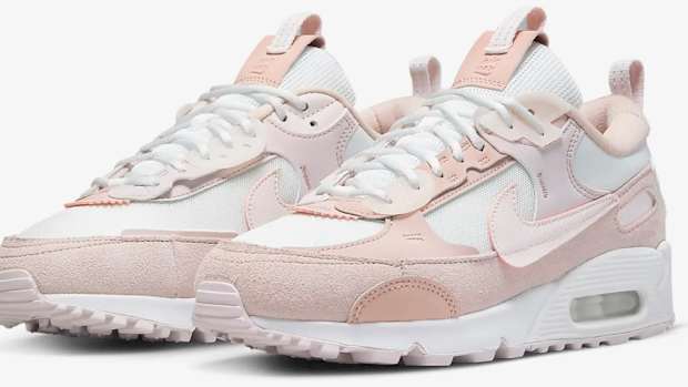 View of pink and white Nike shoes.